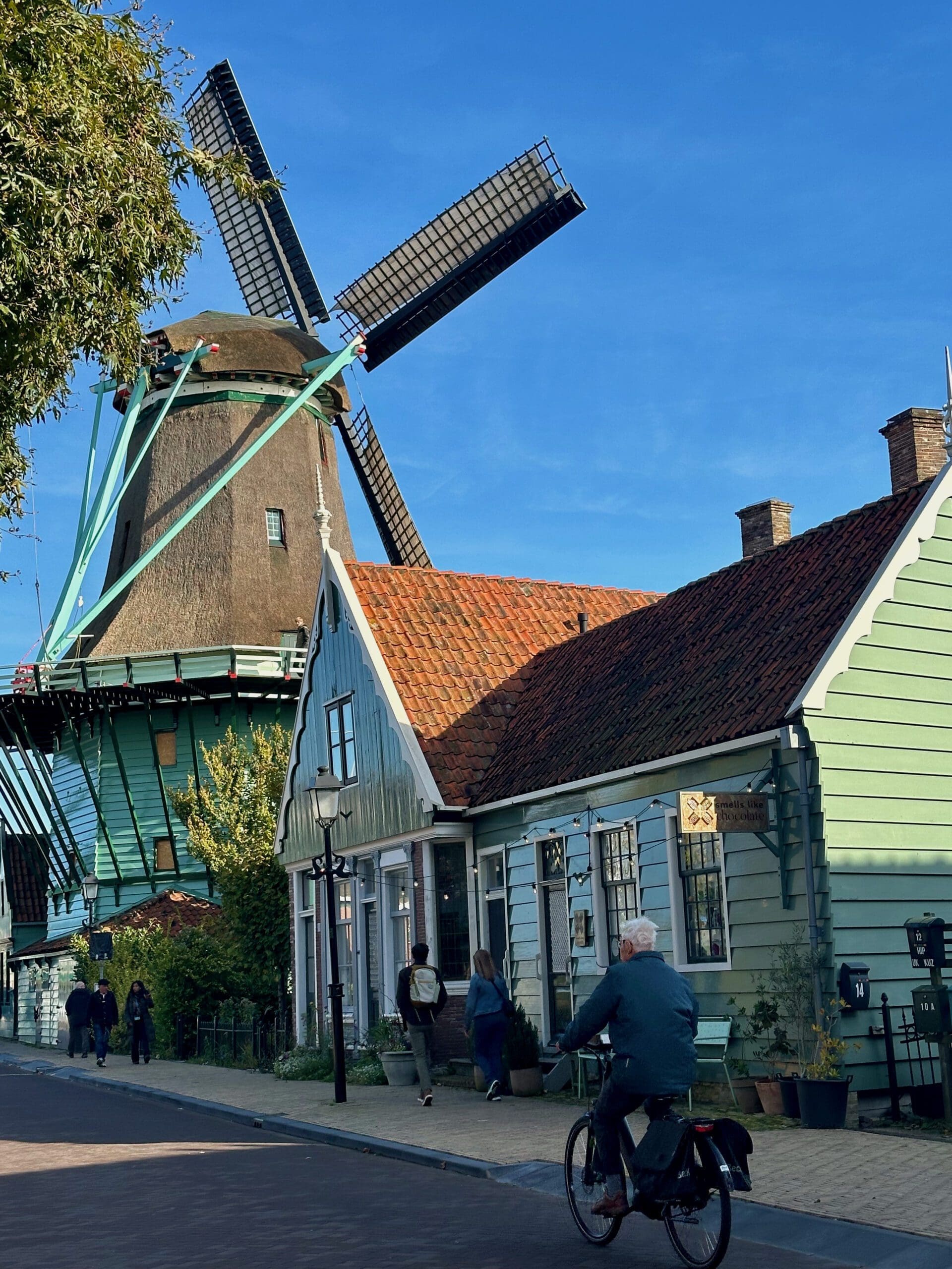 Windmill and traditional green wooden houses at Zaanse Schans, near Amsterdam, Netherlands